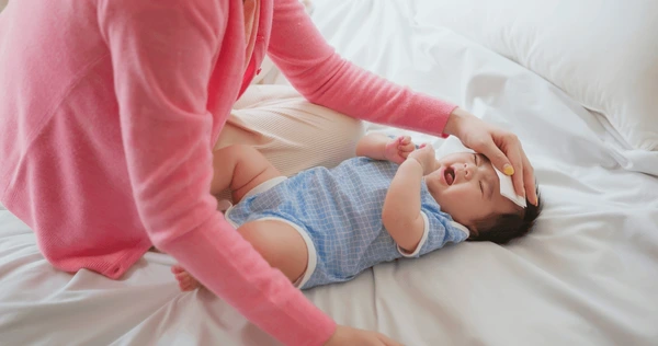 Pediatrician examining infant with fever at Medipoint Hospital Pune